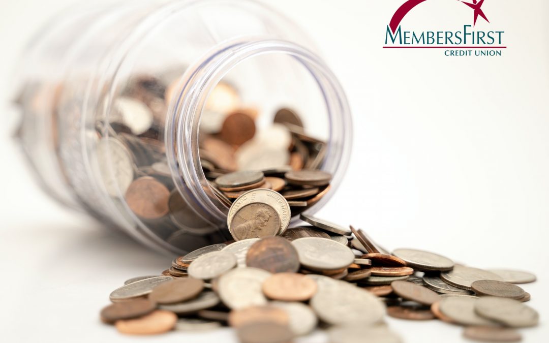 jar of US coins tipped over and spilling contents onto white counter